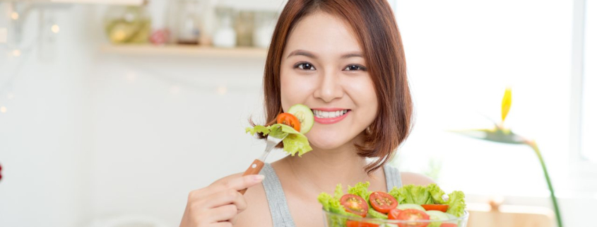 Dieting, healthy food, diet plans. Young woman eating healthy vegetable salad.